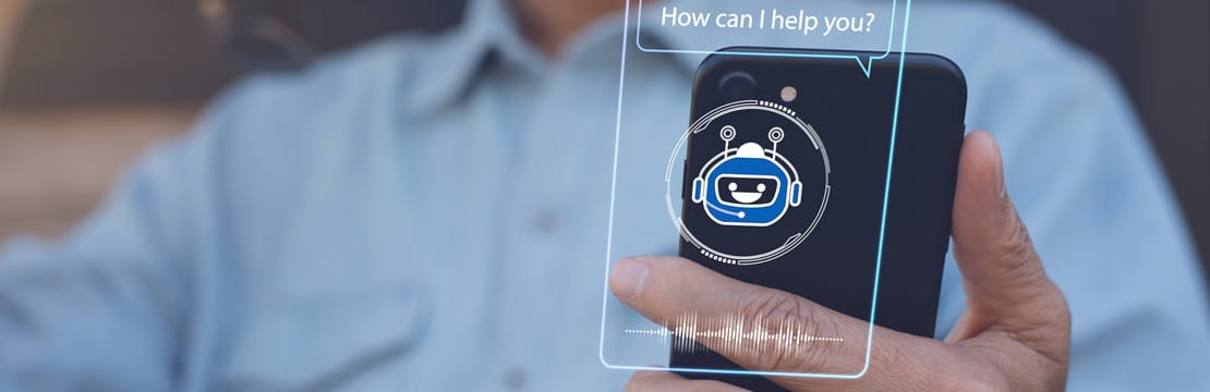 Person using a smartphone with an AI chatbot interface, illustrating how AI chatbots are widely available through mobile apps and digital tools for everyday use.