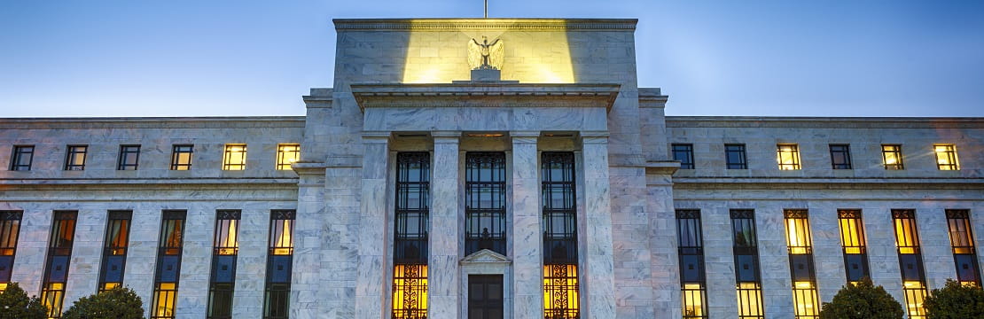 The Federal Reserve building at evening time with lights on