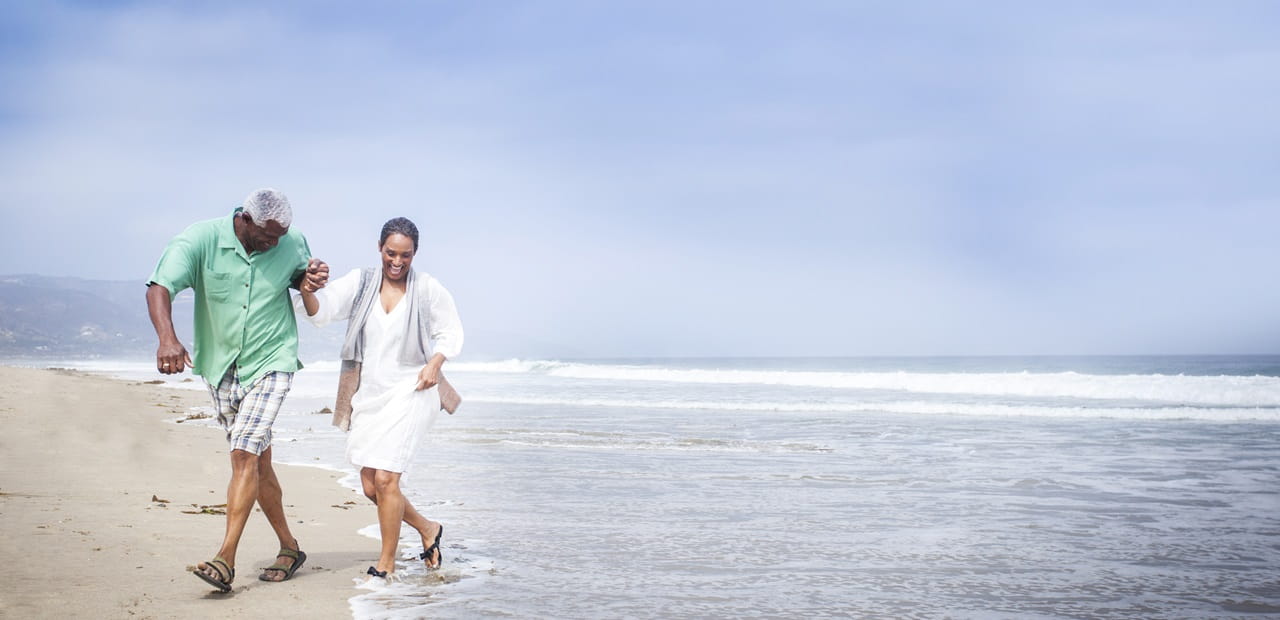 Mature couple having fun on the beach